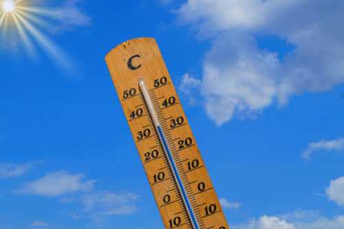A picture of a thermometre and a sunny day